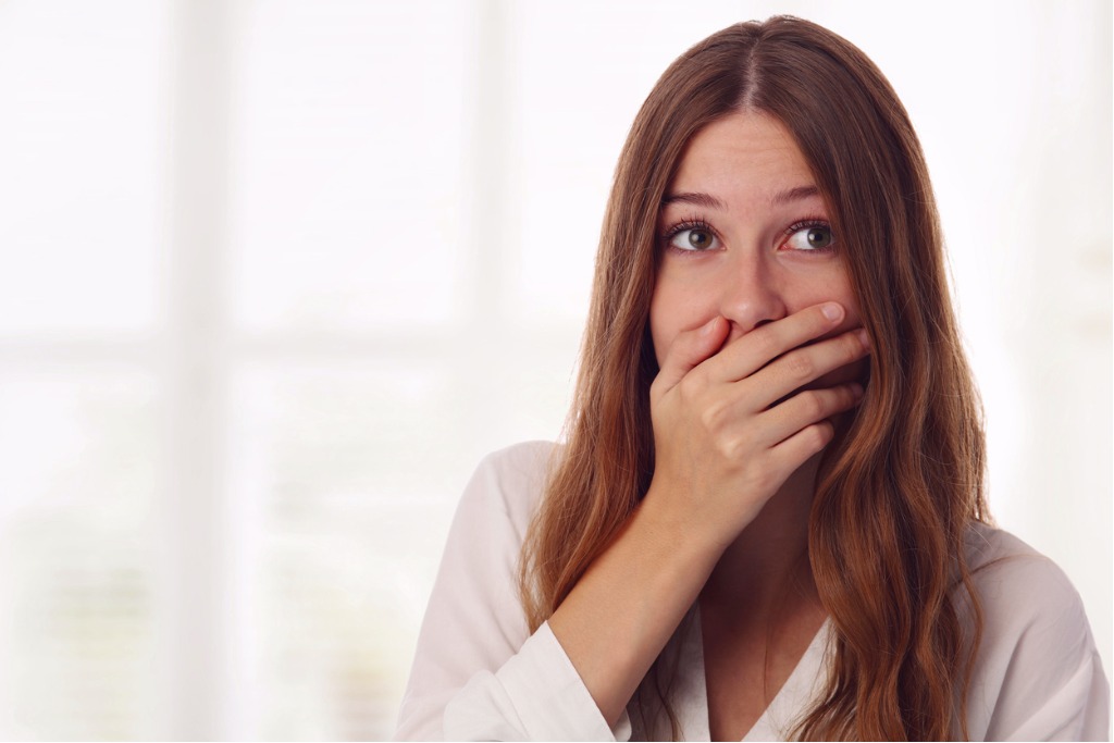 playful-surprised-shy-young-woman-hiding-her-face-laughing-timid-picture-id855617792